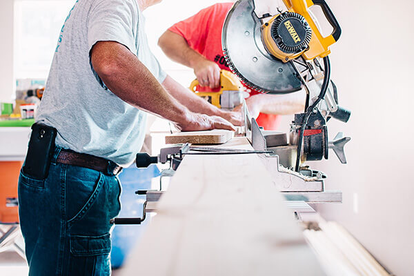 Worker using a power saw