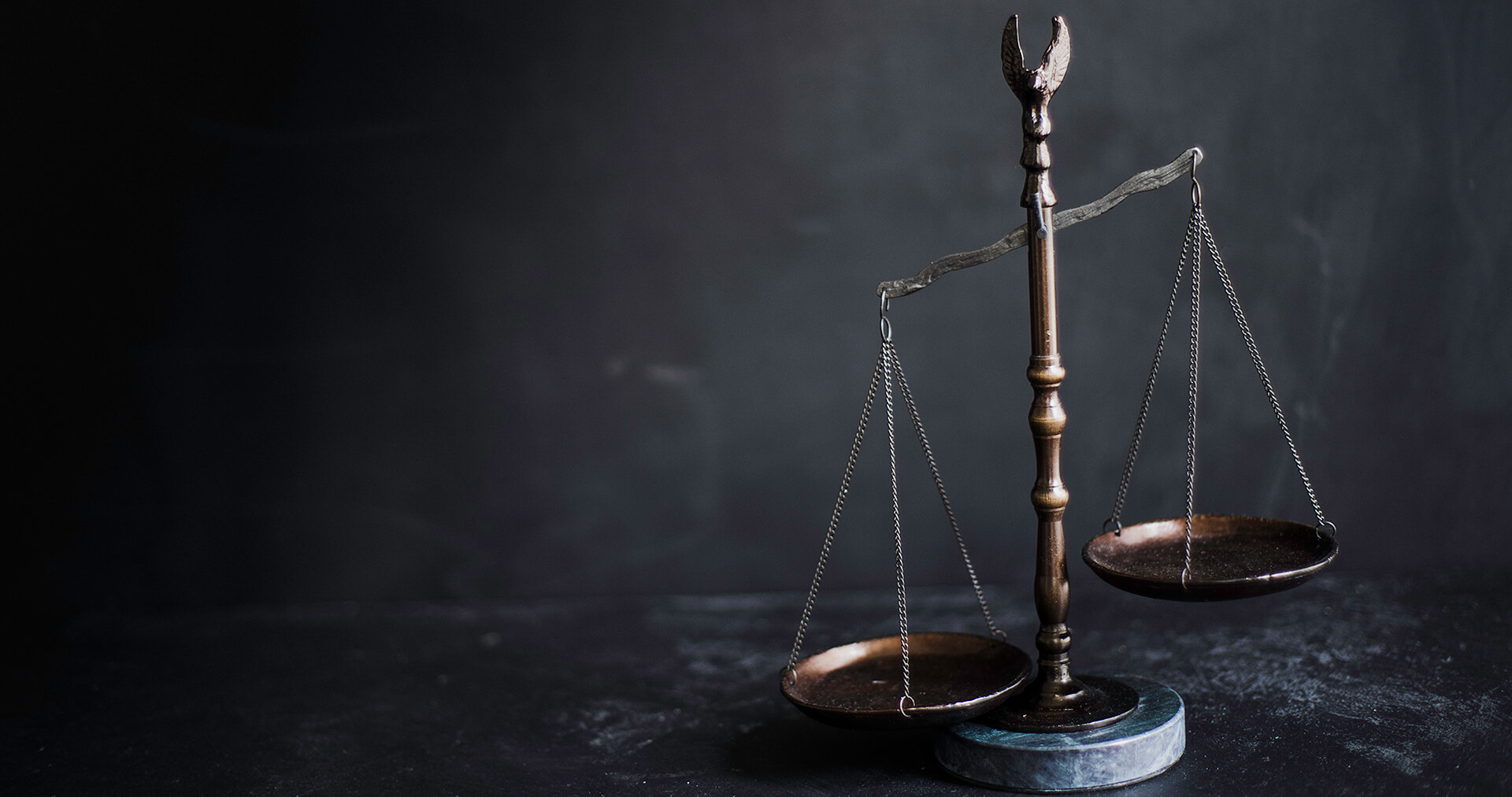 Scales of justice on a dark table